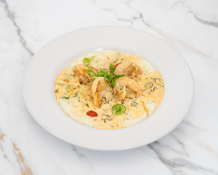 Shrimp and creamy grits with scallions