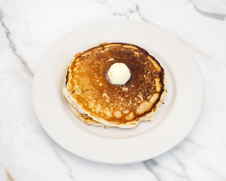 Stack of buttermilk pancakes with whipped butter